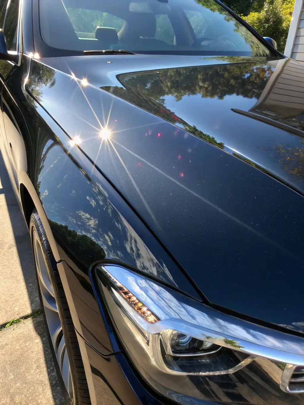 Water beading on a car's surface after ceramic coating application, illustrating its hydrophobic properties and protective qualities.